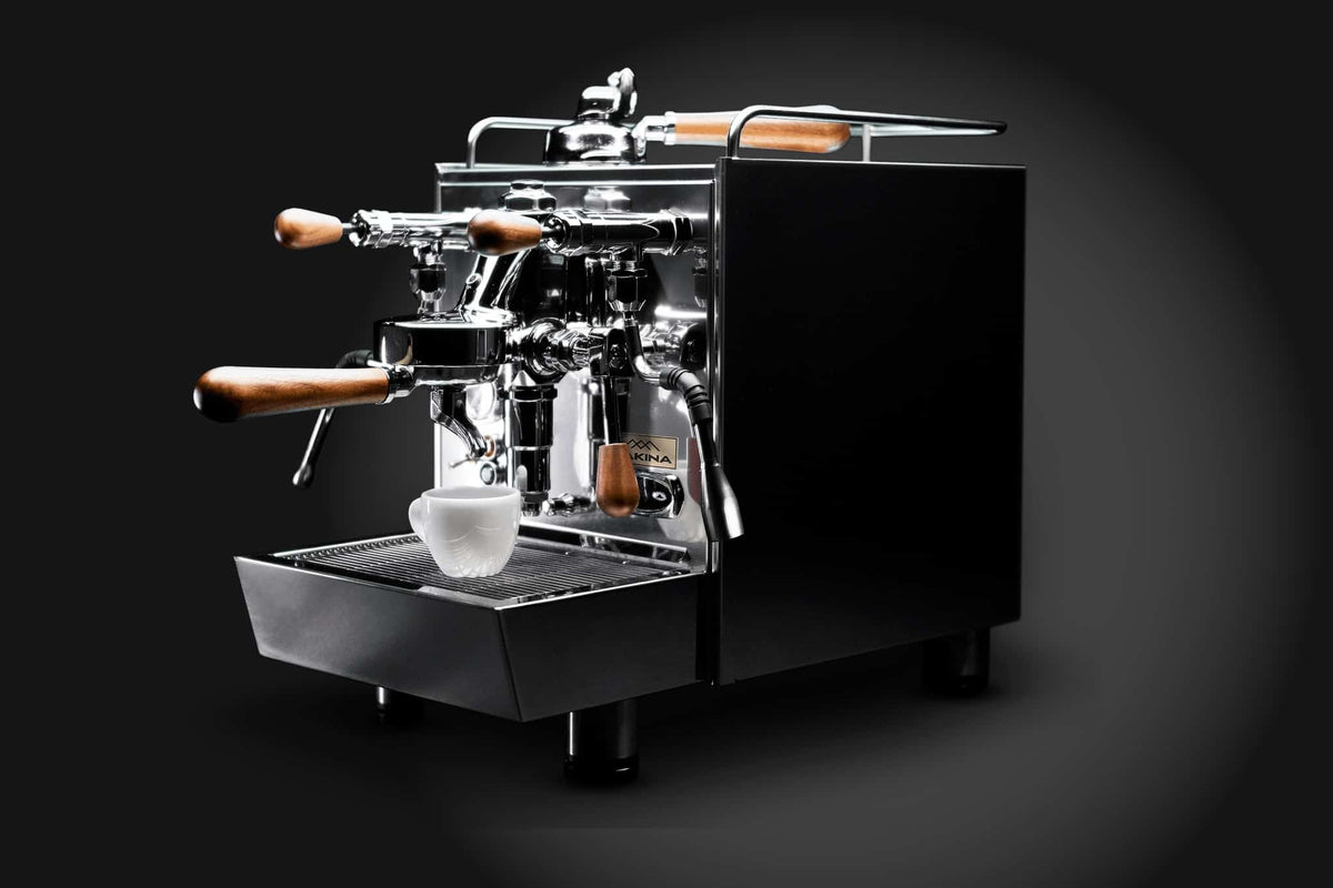MAKINA S7 Pro-PID espresso machine against a dark background, with a cup on the drip tray